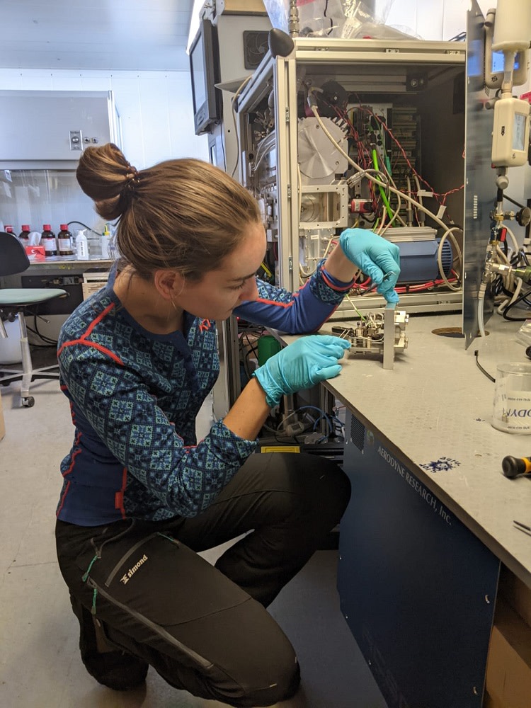 Aerosol scientist Zoé Brasseur repairing an internal component in aerosol mass spectrometers. 
