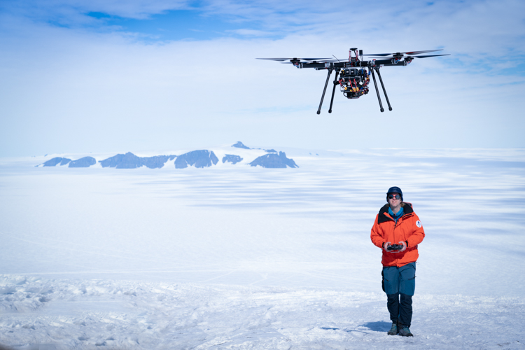 Scientist flying a drone on a glacer close to the Aboa station.