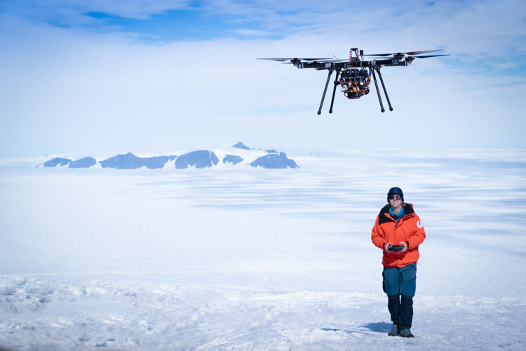 Scientist flying a drone on a glacer close to the Aboa station. 